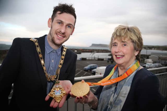 A golden moment for the Mayor of Causeway Coast and Glens Borough Council, Alderman Maura Hickey as she swaps her gold chain for one of Michael McKillopÃ¢Â¬"s Paralympic gold medals during the reception held in his honour in Portnagree House, Ballycastle. PICTURE KEVIN MCAULEY/MCAULEY MULTIMEDIA/CCGBC