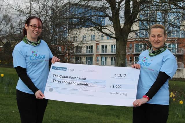 Mother and daughter Gillian (left) and Senga Craig present The Cedar Foundation with Â£3,000 raised through Gillian's participation in the 'Born 2 Run' 'Run Forest Run' series.