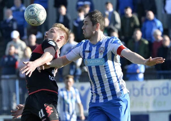 Coleraine's David Ogilby  in action with Crusaders' David Cushley. Stephen Hamilton / Press Eye