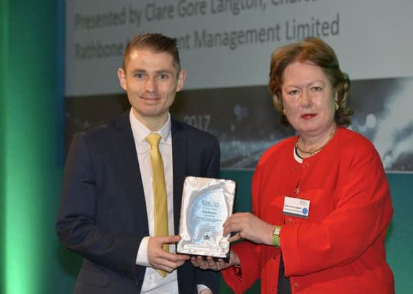 Top performing CISI Candidate, Ryan Maguire, accepts his award in London from Clare Gore Langton, CISI Educational Trust Chairman. (Submitted Picture).