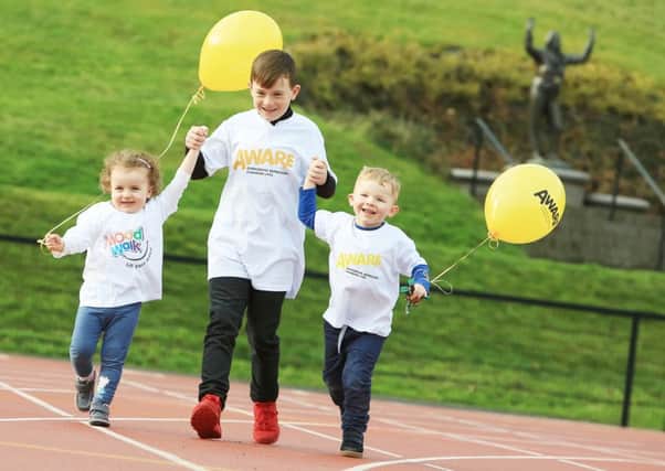 Newtownabbey nine-year-old Reece, his brother Daniel (three) and cousin Sophie (two) get ready for the AWARE Mood Walks.