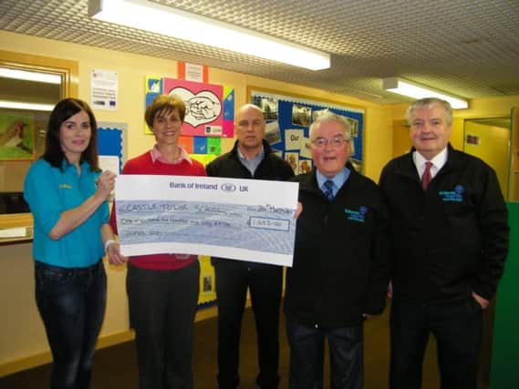 (right to left) Colum Best P.J McAvoy - Directors of Ballymena North Partnership, Jim McCandless (Manager) with teaching staff and Parent teachers association receiving a cheque for Â£1653 from voluntary donation taken up at the Shared Future Concert.