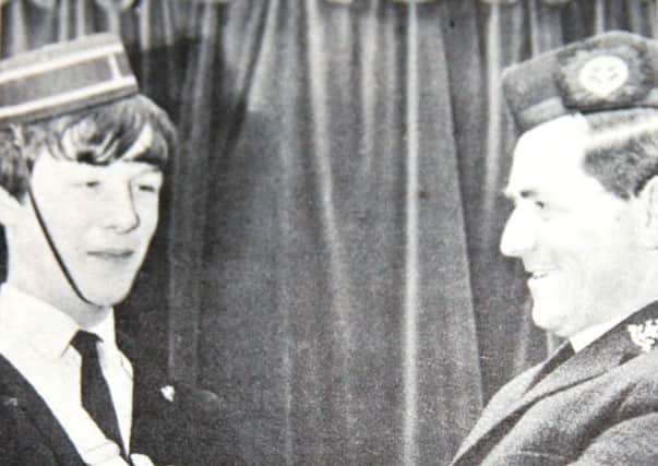 Kenneth Maitland, a member of Cargycreevy Presbyterian Church Boys' Brigade, the first BB member in Northern Ireland to receive the Presidents badge. He is pictured with Rev R Diffen, captain of the company in 1969