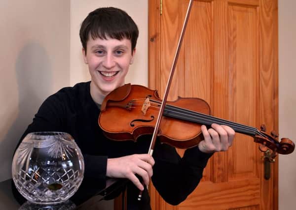 Samuel Kane with his prize and the 1891 violin. INPT14-217.