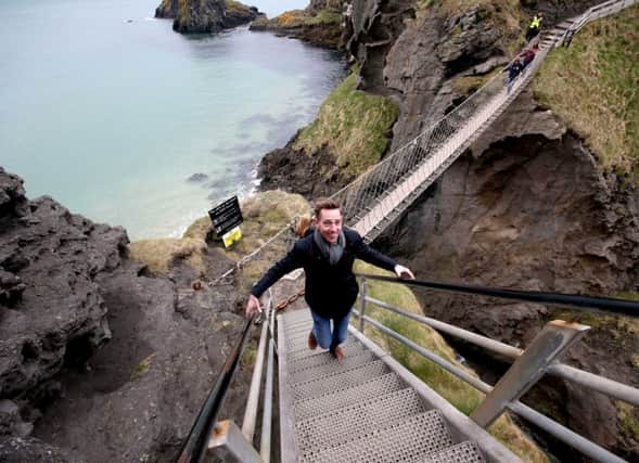 Ryan Tubridy crosses the National Trust's Carrick-a-Rede rope bridge as part of his 'Giant Mini Trip' experience on the North Coast. Pic Steven McAuley/McAuley Multimedia. INCR 15-795-CON