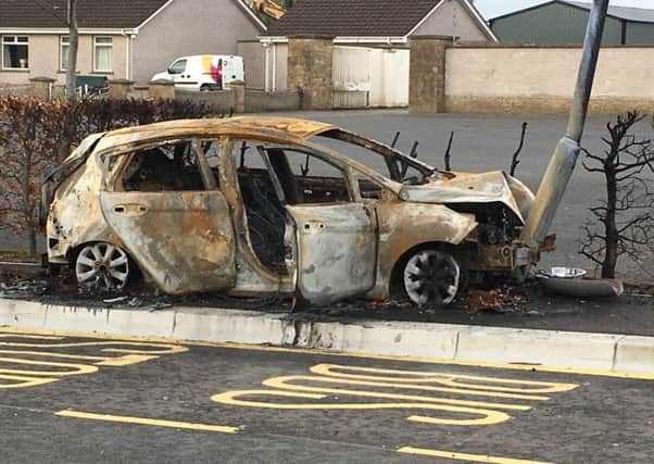 The burnt-out car.
