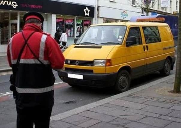 A traffic warden on the look-out for on-street parking contraventions. (Archive pic)