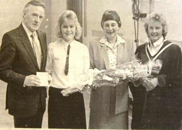 Ballymena Girls School head girl Jacqueline Adams presents Mr and Mrs Eric Russell (special guest) with gifts at the annual prize giving.1989.