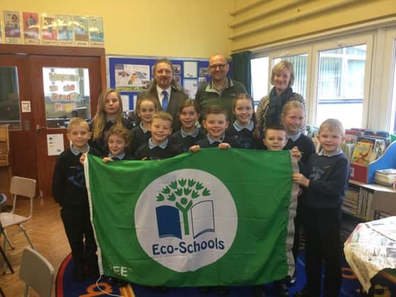 Judges from Eco Schools NI with Mrs Claire Anderson, Eco Coordinator and members of Kilrea Primary School Eco Committee as they show off their ninth Green Flag.