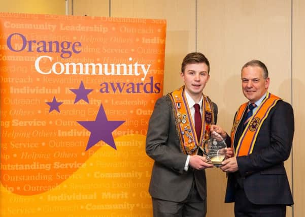 Adam Smyth (left), from Lisburn, receives the Sporting Achievement Award from Stuart Brooker, award sponsor. Adam, a member of St Thomas Temperance LOL 410, was a joint winner in the category in recognition of his success in badminton at the Special Olympics European Championships. Pics by Graham Curry