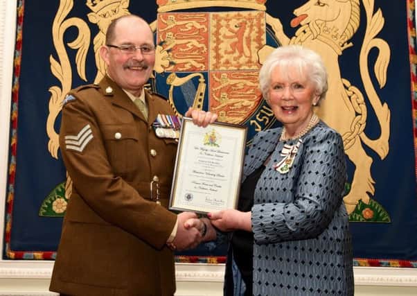 Sgt David Brookes receives The Lord Lieutenants Certificate for Outstanding Meritorious Service Above and Beyond The Call of Duty from Mrs Joan Christie OBE, Her Majestys Lord Lieutenant for the County of Antrim.
