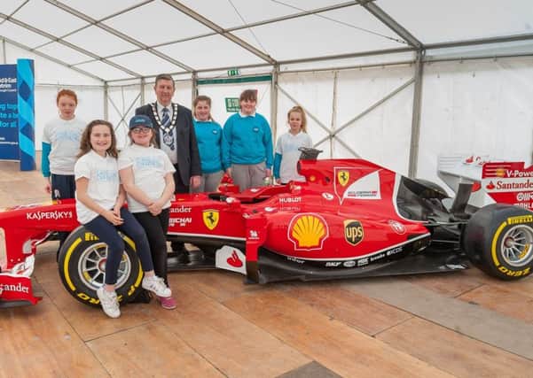 Pupils fron Corran Integrated PS Larne with Mid&East Antrim Deputy Mayor Alderman William McNeilly and the F1 Ferrari.