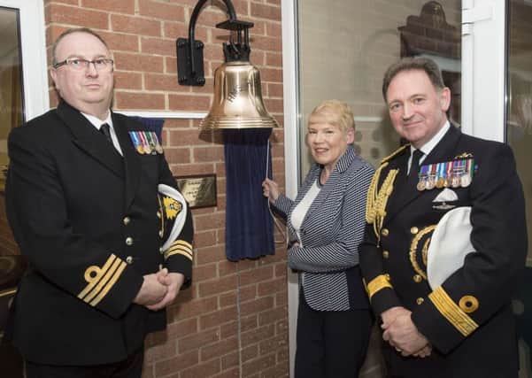 Muriel McMaster unveils the plaque dedicated to her late husband, Lt Commander John McMaster RN. She's pictured with Commander Neil Browning RNR (left), Commanding Officer of HMS Hibernia, and Commodore Martin Quinn, Commander of Maritime Reserves. Pic by Robbie Hodgson