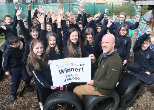 The Coast Office in Portballintrae, Co Antrim, has won Â£50,000 in National Lottery funding in the Big Lottery Funds Peoples Projects for their B.U.I.L.D. project/  Pictured are Lottery Winners,John Bustard,Chairman of Coast office with pupils of Mill Strand Primary school ,Portrush.