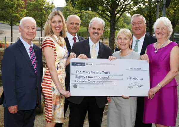 Former Mayor, Councillor Thomas Beckett presents a cheque to the value of Â£81,000 to Dame Mary Peters CH DBE for the Mary Peters Trust.  Also pictured are Freeman of the City, Ivan Davies OBE; Mrs Gillian Hetherington, Mary Peters Trust; Mr Jim Rose, Director of Leisure Services; Mrs Linda Beckett and Mr Pat Catney, MLA.