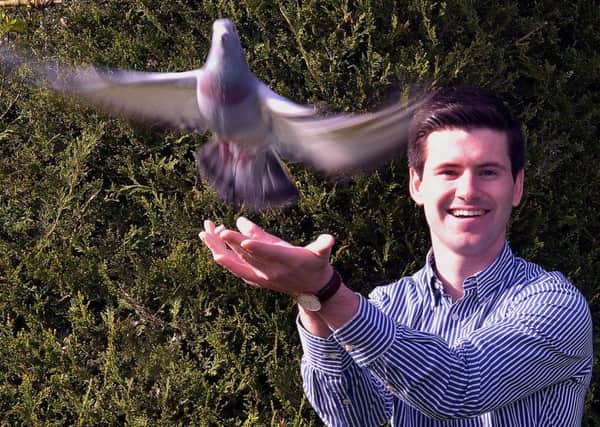 local MLA, Jonathan Buckley with one of his pigeons. INPT14-220.