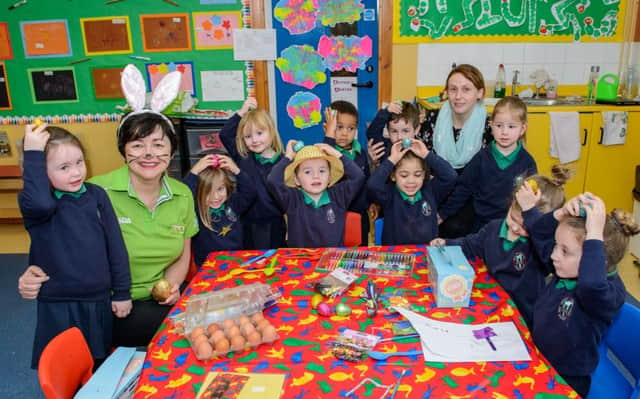 Pictured is Asda Cookstown Community Champion, Janice Gibson with pupils from the Holy Trinity Nursery.