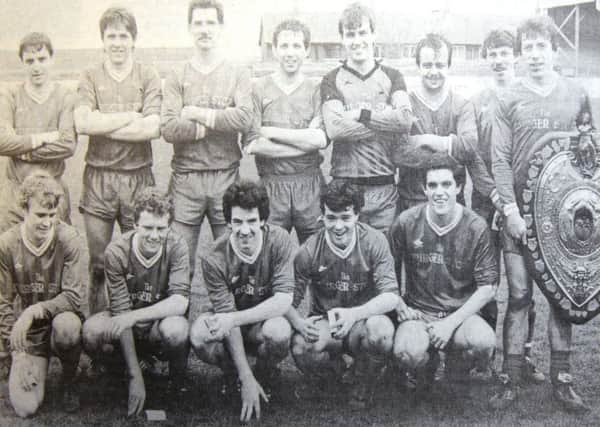 Lurgan United football team after defeating Red in the Mid Ulster Shield  final. Chairman of Mid Ulster football council Ivan Marshall is handing the shielfd to United Captain Peter Murtagh, Back row: Adrian McCann, Shane McConville, Eamon McCoy, Raymond McCann, Raymond Murray, Martin McNeice, Michael McKeown. Front row: Pauil Donnelly, Stephen Greene, Francis Tallon, Connor McCaughley, Colin Headley