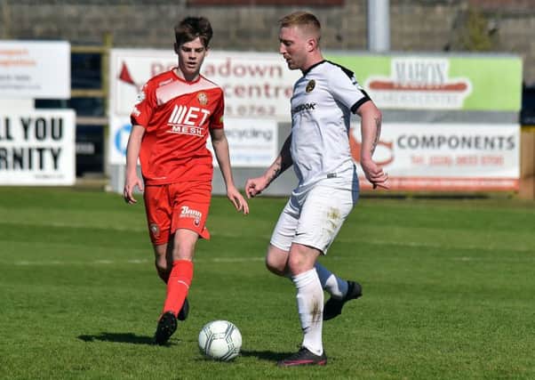 Carrick Rangers' Chris Morrow closed down by 16-year-old Luke Wilson on his senior league debut for Portadown. Pic by PressEye Ltd.