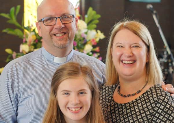 Reverend Canon Mark Harvey with his wife Joanne and daughter Lydia