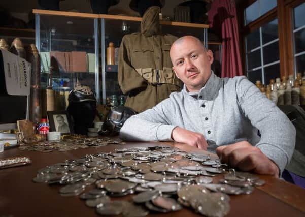Dan Mackay wants to reunite families with dog tags of Second World War heroes. Photo: SWNS