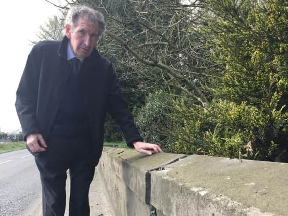 Councillor Shiels inspects the cracked parapet on the bridge