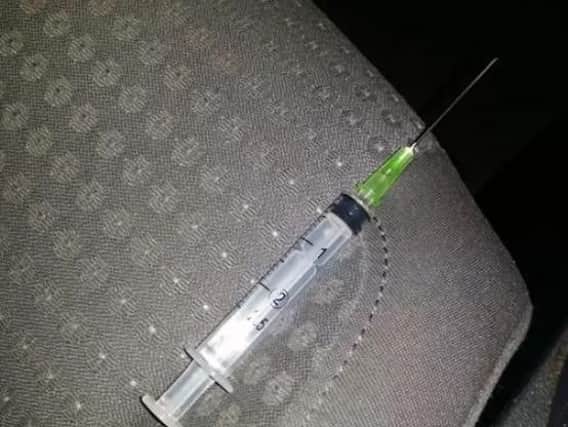 The syringe and needle left in the back seat of the taxi driver's car