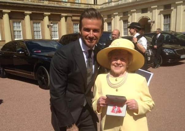 David Beckham congratulates Coleraine's Kathleen McBride on receiving her MBE for services to sport and her work with the NSPCC. David spoke to Kathleen about his time in Coleraine when he played for Manchester United in the Milk Cup tournament.