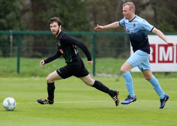 PSNI winger Owen Moody starts to get away from Institute's Sean Roddy. Picture by Declan Roughan/Presseye