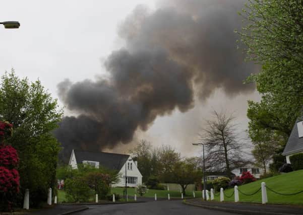 Smoke billows from Derryvolgie House over homes in nearby Richmond Court. Pic by Jim Shields