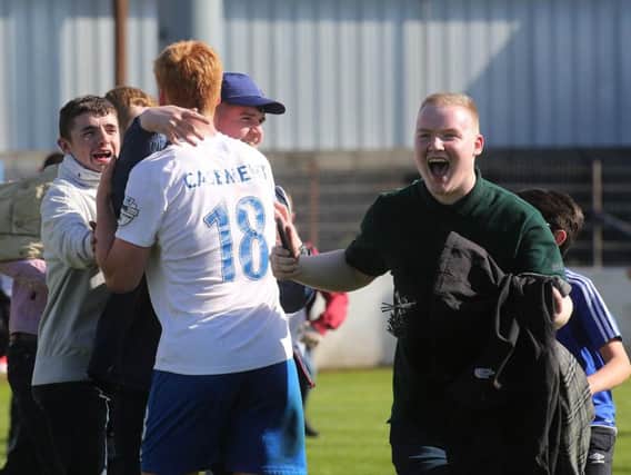 Linfield's Chris Casement celebrates with fans at the final whistle after Saturday's win over Coleraine