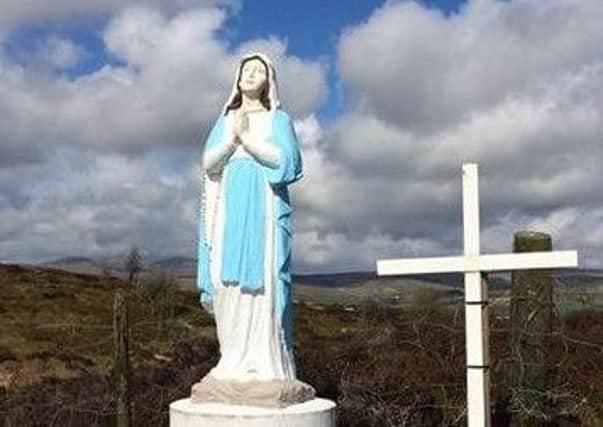 An eight-foot statue of the Virgin Mary has appeared alongside a cross at the site of an historic penal Mass Rock on a gold mine site in Greencastle