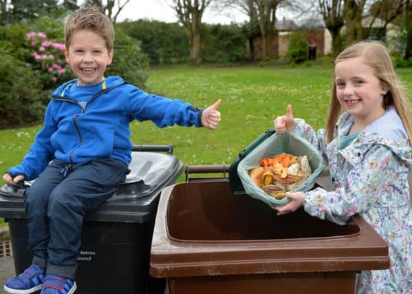 Oscar Millar (4) from Carrick, gives the thumbs-up as Julia Pearson (7) also from Carrick, demonstrates how to recycle - rather than 'bin' - food waste in Mid and East Antrim Borough.  Photo by Aaron McCracken/Harrisons
