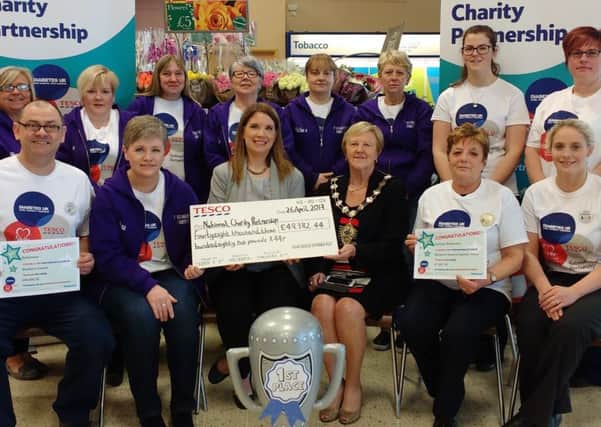 Mayor of Mid and East Antrim, Cllr Audrey Wales MBE,  joins with colleagues from Tesco and charity representatives to mark the fundraising milestone.