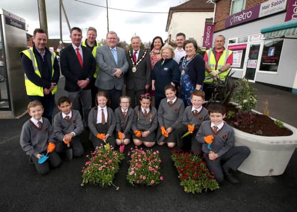 Mayor Brian Bloomfield MBE with local political and community representatives, council staff and pupils from Harmony Hill Primary School checking out the improvements at Moss Road.