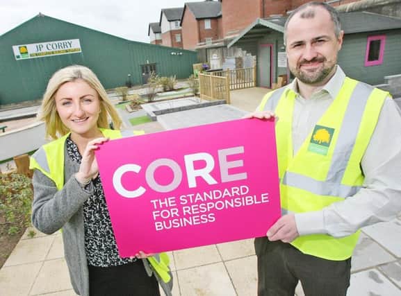 Mandy McQuillan and Francis Goodall of JP Corry, Springfield Road with the CORE The Standard for Responsible Business award.