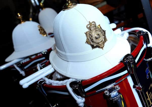 The famed white head dress known as the Pith Helmet worn by Her Majesty's Royal Marines Band rests on top of drums prior to a performance.