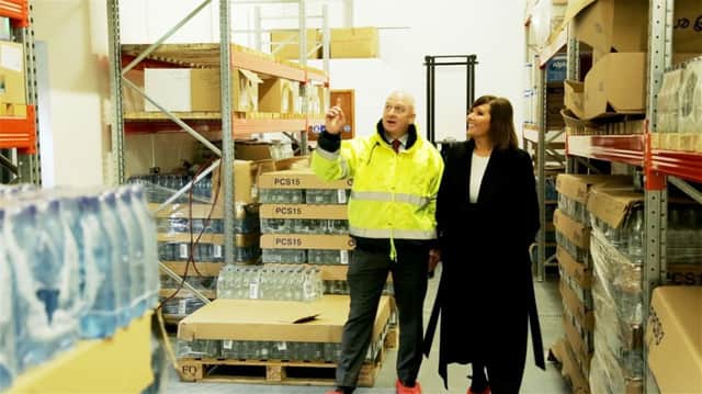 David Hunter from AEL tours the Larne bottling facility with the Housing Executives Head of Communities Jennifer Hawthorne.