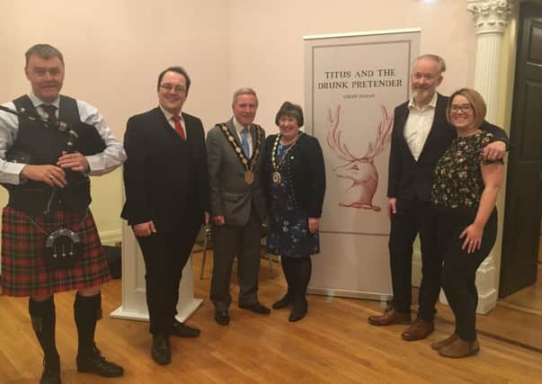 Author Colin Sloan with Lisburn Councillor Alexander Redpath, Mayor Brian Bloomfield, Lady Mayoress Rosalind Bloomfield, Waterstone Lisburn Manager Zoe Rainey and the piper who welcomed everyone to the launch