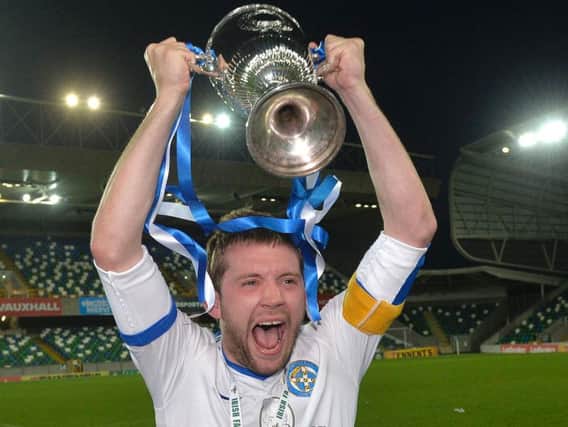 Limavady United captain Hugh Carlin lifts the Intermediate Cup at Windsor Park.