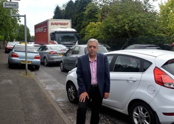Councillor David Jones pictured outside the Hart Memorial Primary School at 3pm yesterday. The councillor is calling for a crossing to make it safe for pupils to cross the busy road at Charles St. INPT20-212.