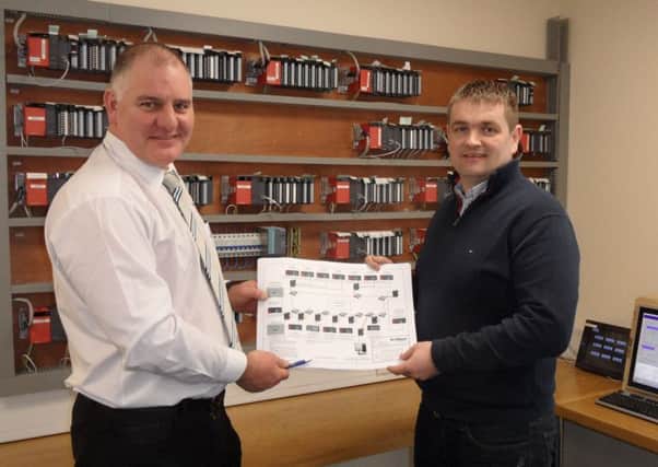 NI Water Project Manager Aaron Vogan pictured with Declan Bennett reviewing the panels which are produced at the Cookstown firm