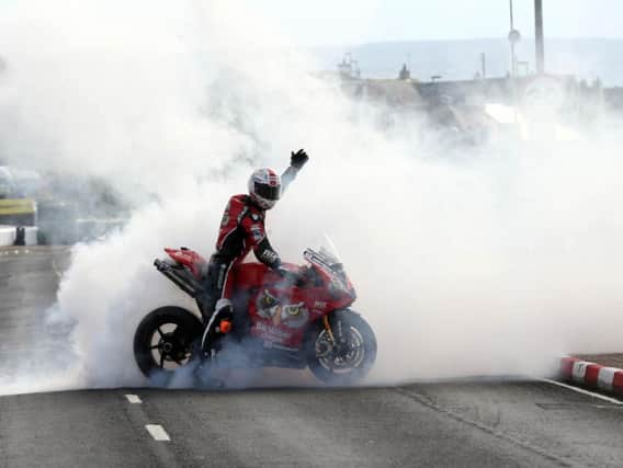 Glenn Irwin celebrates his Superbike victory at the North West 200.
