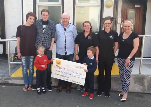 Pictured at the cheque handover are members of the Milliken family with Emma Robb (Emolsie Catering), Chelsea Brown (The Highway Inn) and Kimberley Hill (TinyLife).