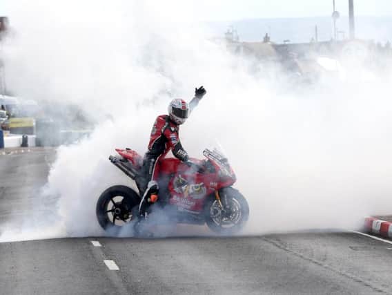 Glenn Irwin celebrates his NW200 Superbike win with a burnout on the PBM Ducati.