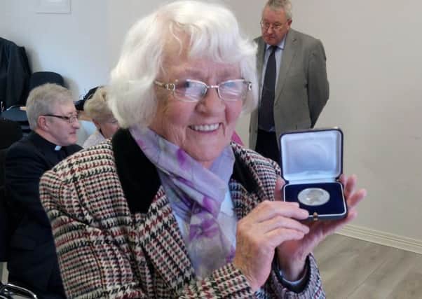 Ruby Jordan with the medal awarded to her great-great-grandfather Daniel Gallagher for his service during the Peninsular War of the early 19th century