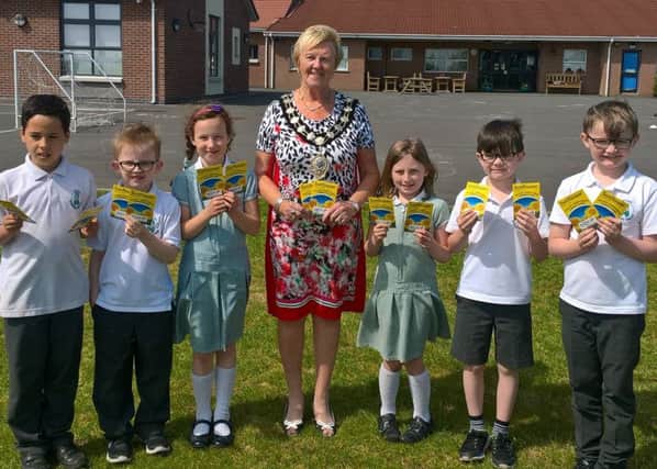 Mayor Cllr Audrey Wales distributes seeds for the Tallest Sunflower competition.