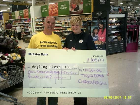 Pictured at the cheque presentation are  Mark McGivern, Development officer for Angling First and  Ann Ritchie, Tesco Extra Community Champion. 
INCT 21-701-CON