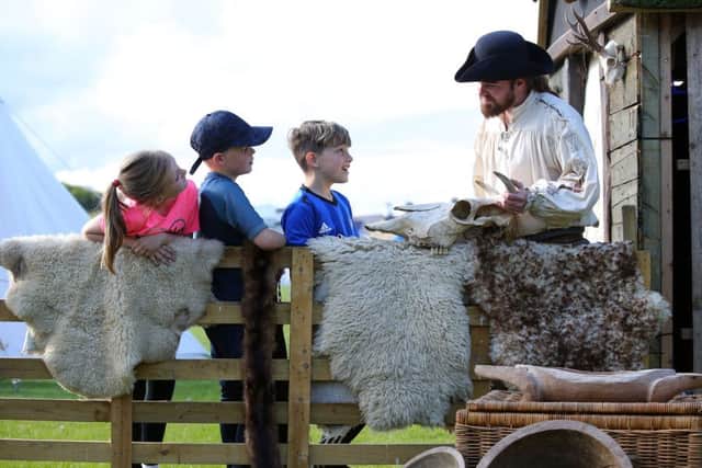 Young visitors enjoy the Friends' Goodwill Festival with Michael Woods at the Living History Village.

Photo by Kelvin Boyes / Press Eye.