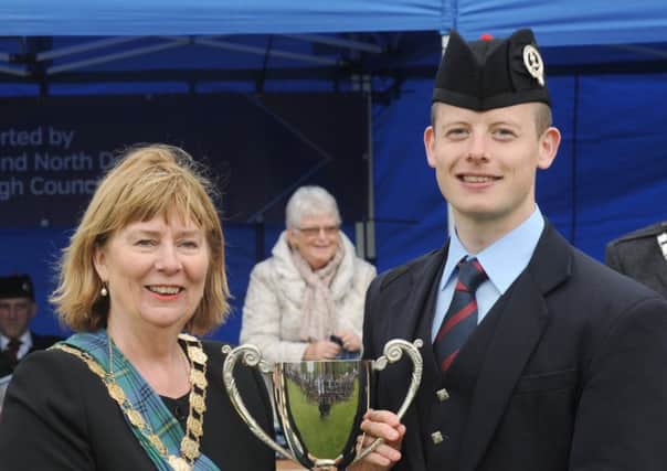Alan MacPherson (Field Marshal Montgomery Pipe Band) pictured receiving the Best Pipe Corps trophy from Alderman Deborah Girvan, Chieftain of the gatherin (Mayor of Ards and North Down) at the Ards and North Down Pipe Band Championships at Bangor on Saturday 13th May.